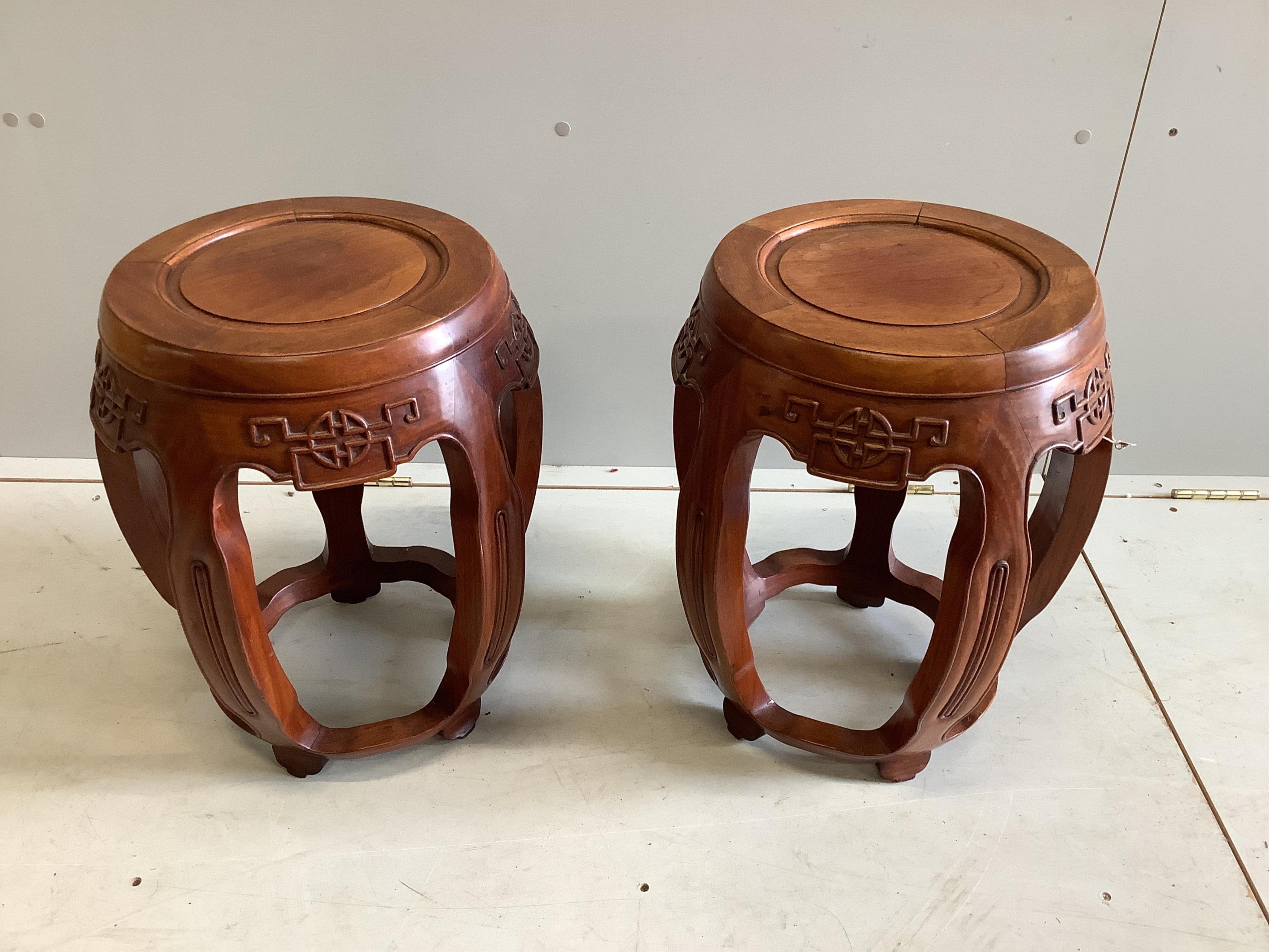 A pair of Chinese carved hardwood jardiniere stands, diameter 38cm, height 46cm. Condition - good